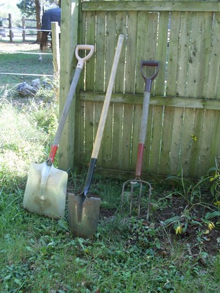 snow shovel, a spade and a manure fork for moving a compost pile