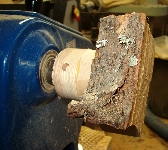 tealight blank fastened to bowl lathe with a hot glue block