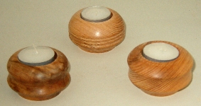 three woodturning tealights finished for display