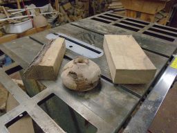  A couple of chunks of hardwood and a partly turned maple burl are kept  