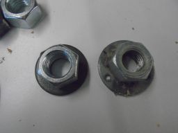 	Faceplate of a nut welded to a washer and three holes drilled in it.	