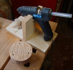  Hot glue from a glue gun is applied to the block